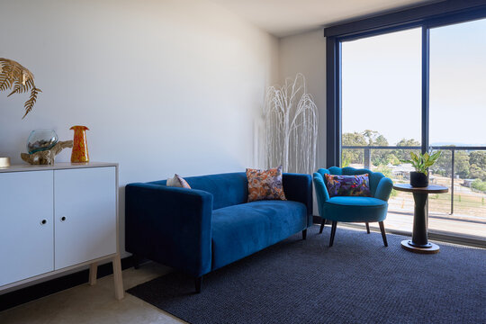 Small lounge room with blue velvet couch