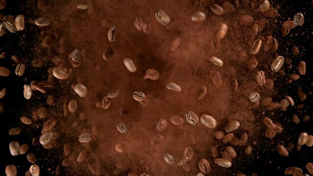 Super slow motion of rotating coffee beans on black background. Filmed on high speed cinema camera, 1000 fps. Speed ramp effect.