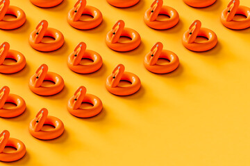 Inflatable flamingo on yellow with copy space.