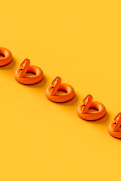 a row of Inflatable flamingos on yellow background. 