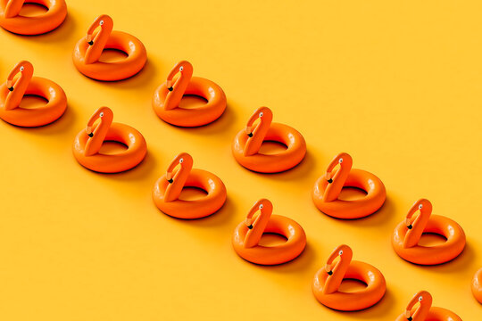 rows of Inflatable flamingos on yellow background. 