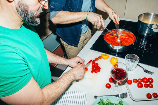 Men Making Sauce For Pasta At Home