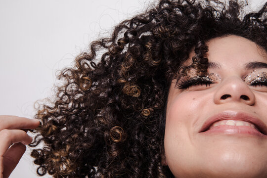 Model with curly hair and sparkly eyeshadows