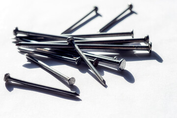Close up view of metal nails for fastening. Nail is made in a great variety of forms for specialized purposes. The most common is a wire nail.