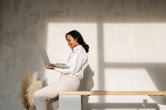 Content Black Woman Browsing Laptop