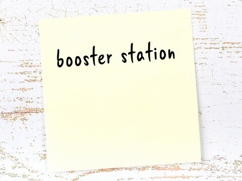 Yellow Sheet Of Paper With Word Booster Station. Reminder Concept