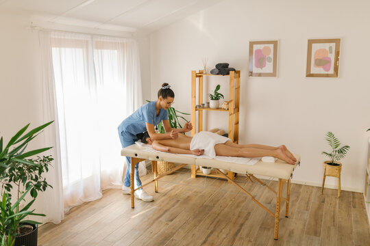 Woman getting professional back massage at spa