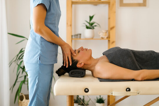 Mature woman having face massage at spa