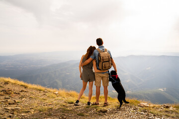 back view of Happy couple in nature at sunset