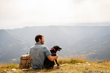 Portrait of happy man with his dog in nature