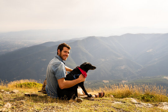 Portrait of happy man with his dog in nature