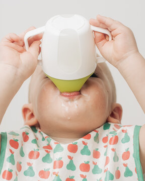 Anonymous Baby Drinking From A Sippy Cup Close Up