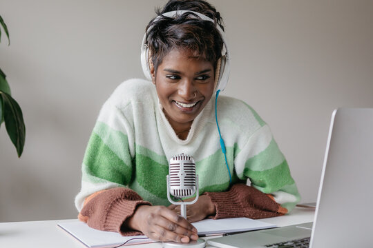 Woman entrepreneur smiling during a podcast interview