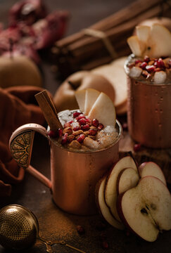 Cocktail with pear, apple, pomegranate and cinnamon, close-up