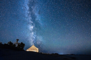 Bell Tent With Milky Way Night Sky and Windswept Pines