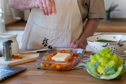 Senior man cooking preparing healhty meal in kitchen