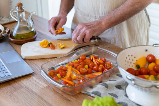 Senior man cooking preparing healhty meal in kitchen