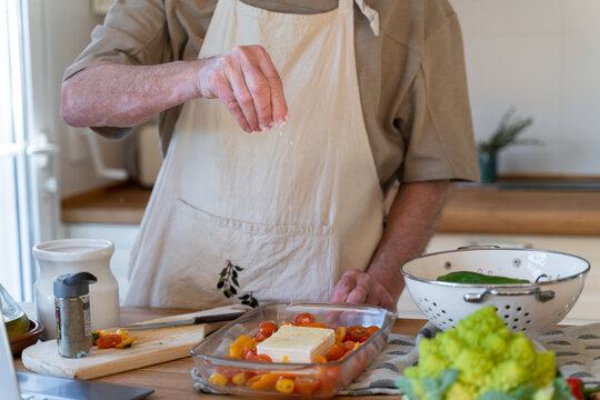 Senior man cooking preparing healhty meal in kitchen