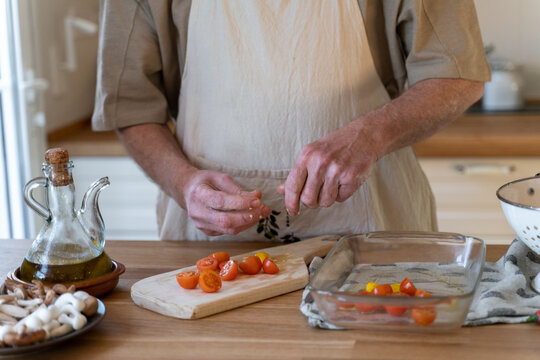 Senior man cooking preparing healhty meal in kitchen