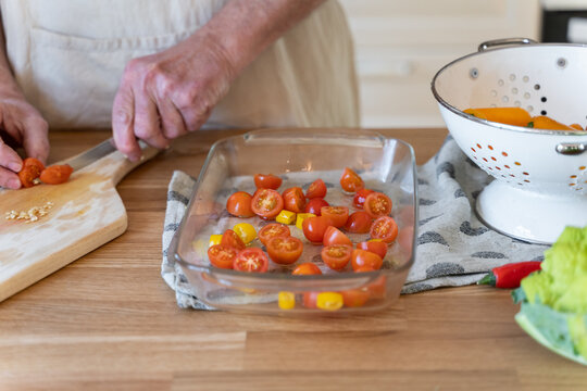 Senior man cooking preparing healhty meal in kitchen