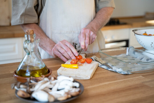Senior man cooking preparing healhty meal in kitchen