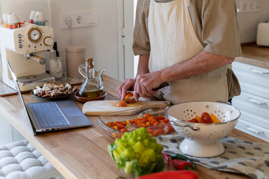 Senior man cooking preparing healhty meal in kitchen