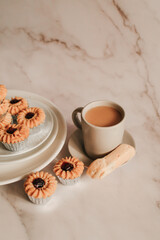 Homemade cookie with jam and hot coffee on marble table in morning tone. Breakfast meal.