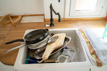 Pile of dirty dishes in the kitchen sink