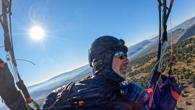 profile portrait of a man flying a paraglider