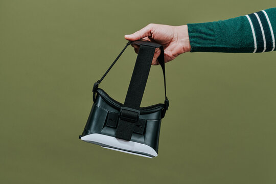 holds a virtual reality headset in his hand