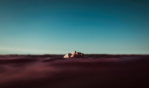 Androgynous woman floating in the sea