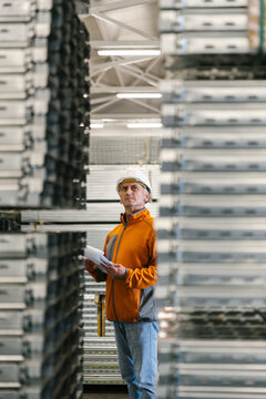 Man Checking Production Statistics Of Aluminium Profiles