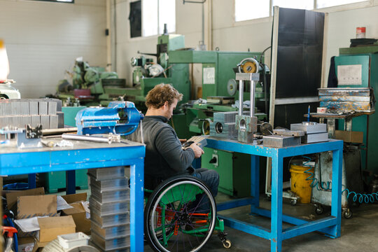 Disabled Man Working In His Workshop