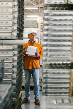 Man Checking Production Statistics Of Aluminium Profiles