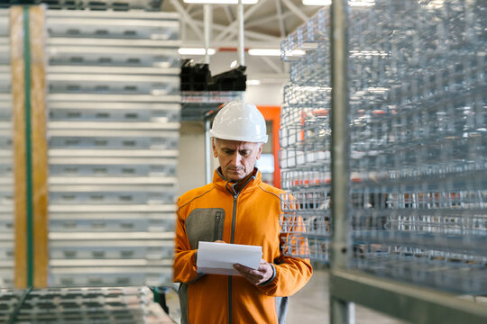 Man Checking Production Statistics Of Aluminium Profiles