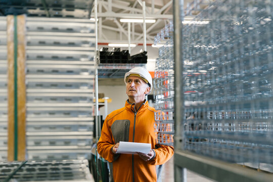 Man Checking Production Statistics Of Aluminium Profiles