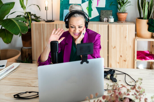 Senior woman smiling doing online interview