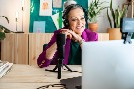 Senior woman smiling doing online interview