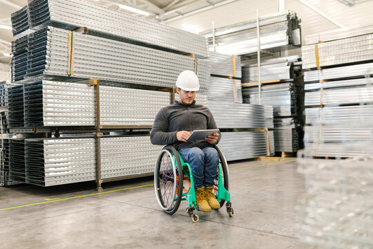 Male Worker Using His Tablet In A Warehouse