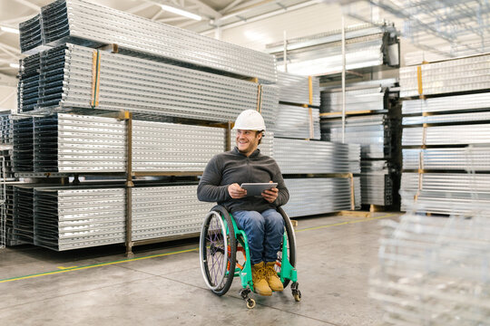 Male Worker Using His Tablet In A Warehouse