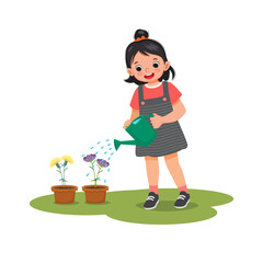 Happy cute little girl watering plants flowers in the pot with watering can in the garden