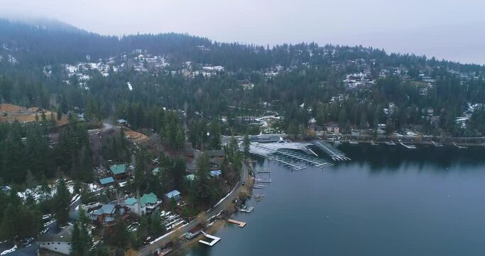 Hayden Lake with an empty pier and wintery mountains