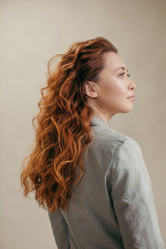 Profile of woman with amazing curly red hair 
