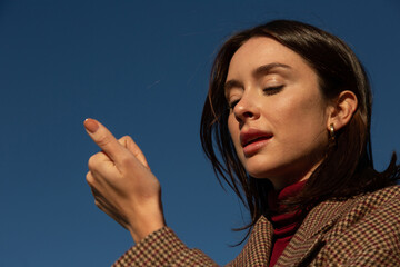 an natural  woman looks at her manicure 