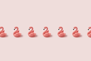 Row of pink easter flamingo on pastel background