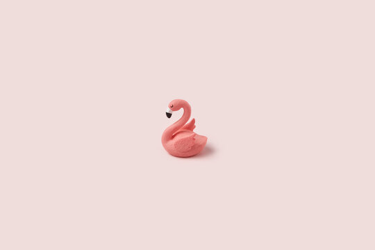 Figure of pink easter flamingo on pastel background