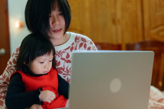woman and child using laptop