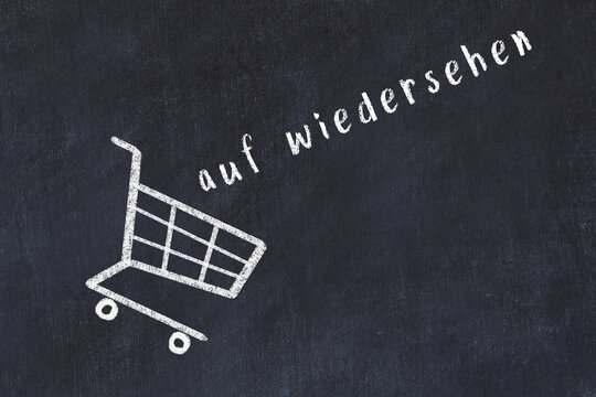 Chalk drawing of shopping cart and word auf wiedersehen on black chalboard. Concept of globalization and mass consuming