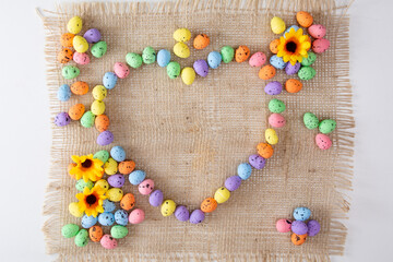 Colored easter eggs on white backdrop in the hearth shape. Flat lay minimal holiday concept. I love easter.