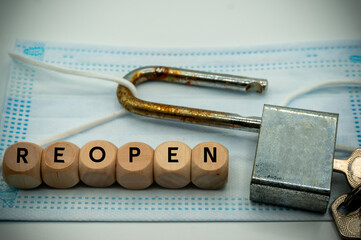 economic activity and back to work.coronavirus.Open locking medical mask.wooden Dice says 